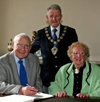 Mayor of Ballymena, Councillor Maurice Mills, with local music teacher Robert Farren and his wife Maureen, at a special reception for Robert to mark his retirement. Photo courtesy of the Ballymena Times